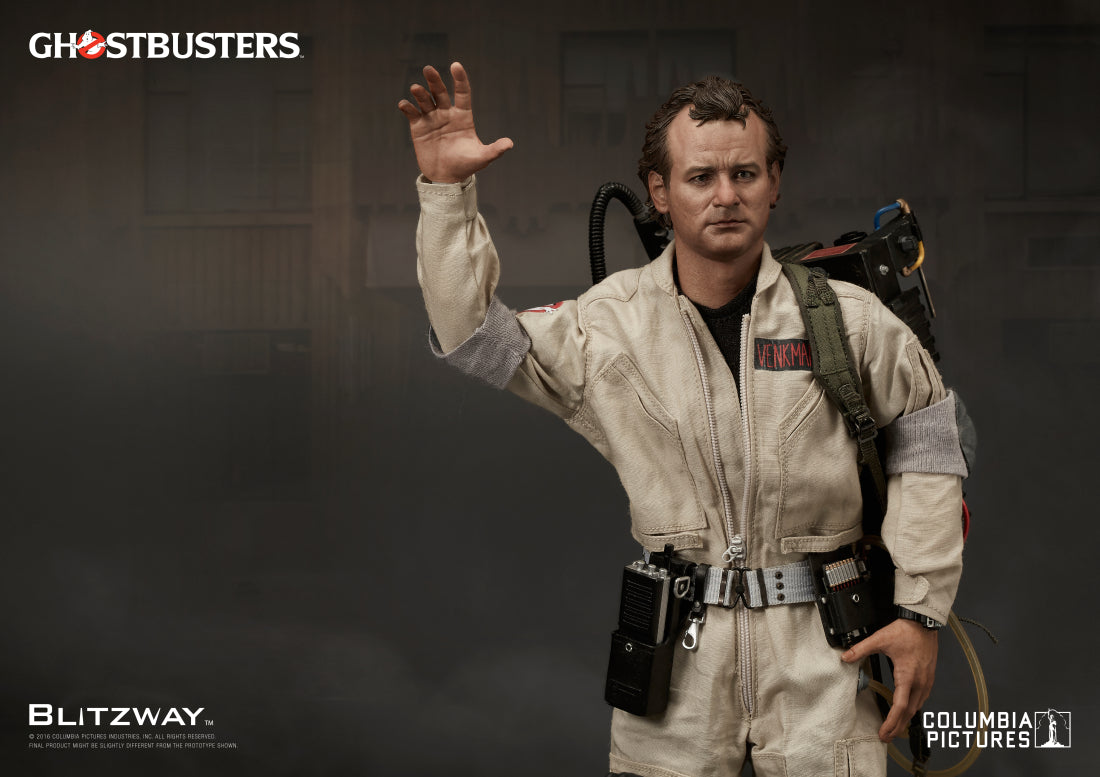 1/6 scale action figure of Peter Venkman from Ghostbusters by Blitzway, posed with one arm raised in a waving gesture, wearing a full beige jumpsuit and proton pack against a moody urban backdrop.